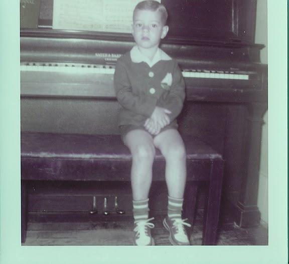 Ronnie on piano bench 1950s.jpg